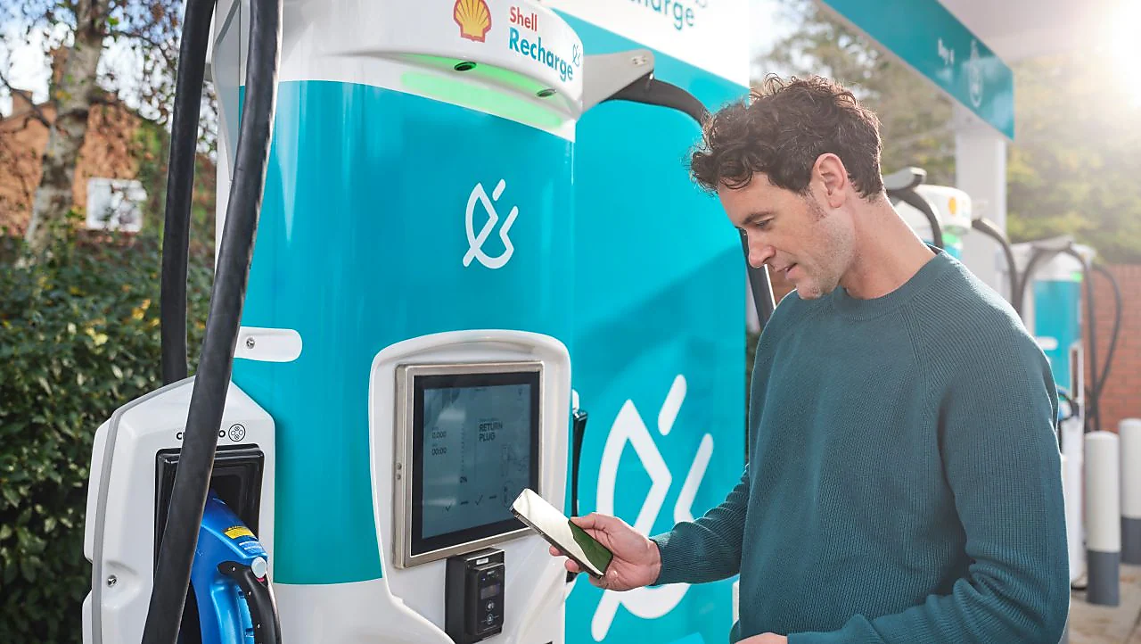 man charging at shell station 